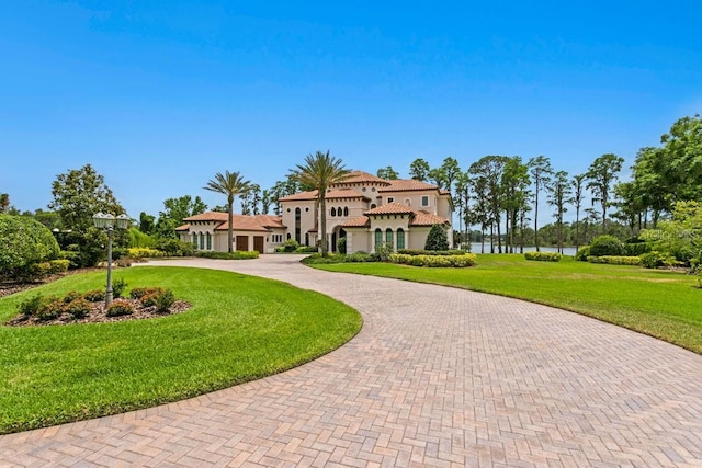 17124 Crawley Rd, Odessa, FL 33556 - view of front of property featuring curved driveway, a front yard, stucco siding, and a tile roof