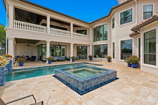 17124 Crawley Rd, Odessa, FL 33556 - back of house with a balcony, a ceiling fan, outdoor lounge area, a patio area, and an in-ground hot tub