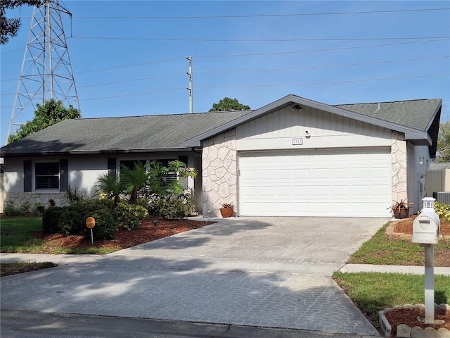 3357 Hunt Club Dr, Clearwater, FL 33761 - view of front of property featuring stone siding, driveway, a garage, and roof with shingles