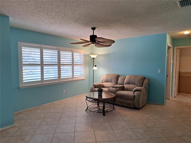 3357 Hunt Club Dr, Clearwater, FL 33761 - living area with ceiling fan, light tile patterned floors, and a textured ceiling