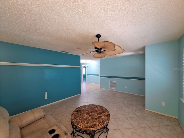 3357 Hunt Club Dr, Clearwater, FL 33761 - tiled empty room featuring a ceiling fan, a textured ceiling, and baseboards