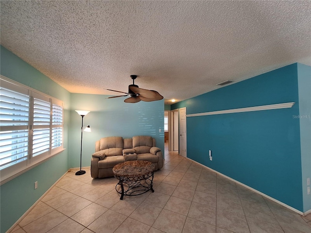 3357 Hunt Club Dr, Clearwater, FL 33761 - living area featuring a ceiling fan, a textured ceiling, tile patterned floors, and baseboards