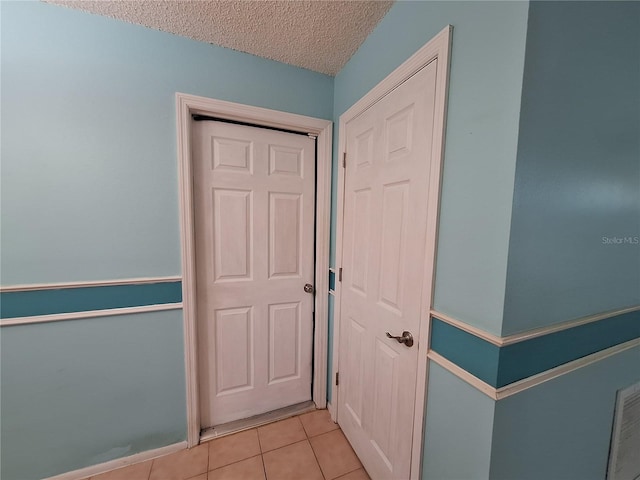 3357 Hunt Club Dr, Clearwater, FL 33761 - hall featuring light tile patterned flooring and a textured ceiling