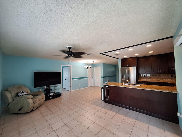 3357 Hunt Club Dr, Clearwater, FL 33761 - kitchen with stainless steel fridge, dark brown cabinets, a chandelier, a sink, and ceiling fan