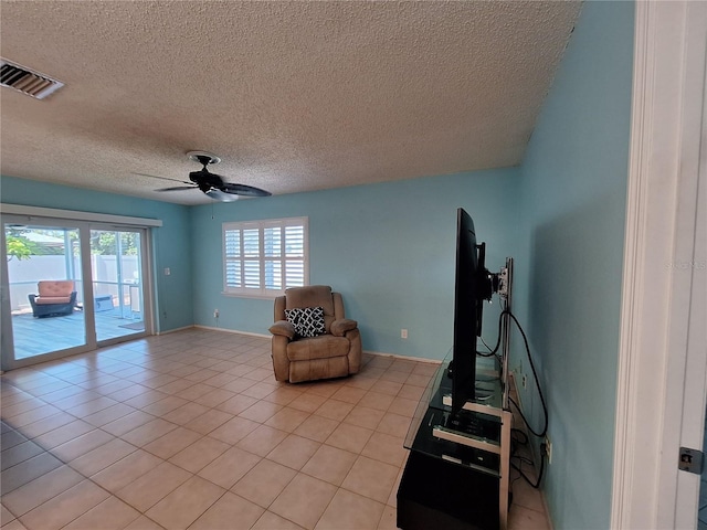 3357 Hunt Club Dr, Clearwater, FL 33761 - living area with ceiling fan, a textured ceiling, light tile patterned flooring, and baseboards