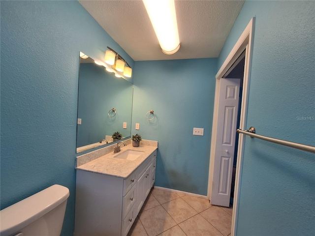 3357 Hunt Club Dr, Clearwater, FL 33761 - bathroom featuring toilet, vanity, a textured ceiling, tile patterned flooring, and a textured wall