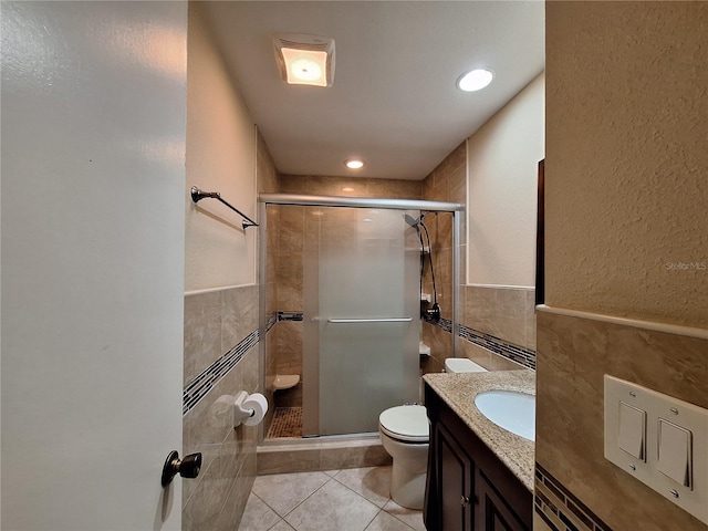 3357 Hunt Club Dr, Clearwater, FL 33761 - full bath featuring tile walls, toilet, tile patterned floors, a stall shower, and vanity