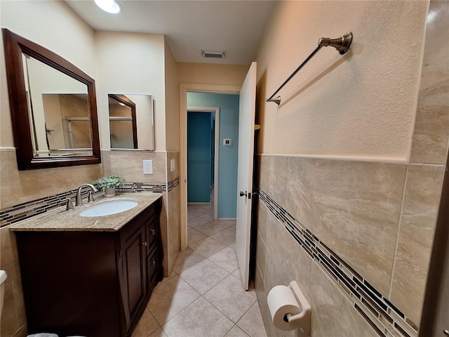 3357 Hunt Club Dr, Clearwater, FL 33761 - bathroom with tile walls, vanity, tile patterned flooring, and wainscoting