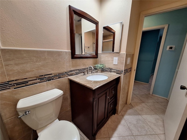 3357 Hunt Club Dr, Clearwater, FL 33761 - bathroom featuring vanity, tile walls, toilet, tile patterned floors, and wainscoting