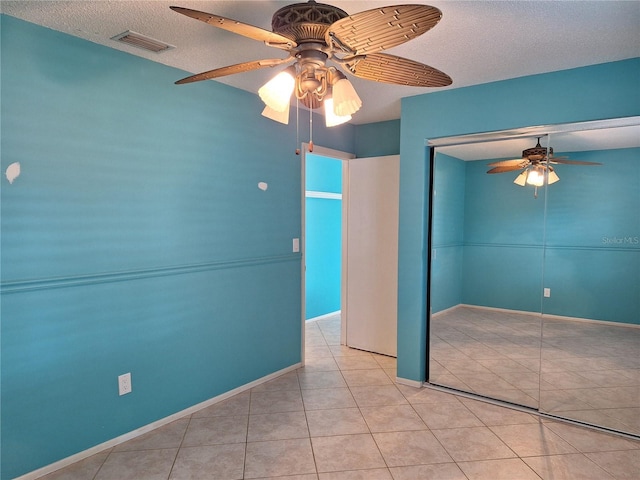 3357 Hunt Club Dr, Clearwater, FL 33761 - unfurnished room with a ceiling fan, a textured ceiling, tile patterned flooring, and baseboards