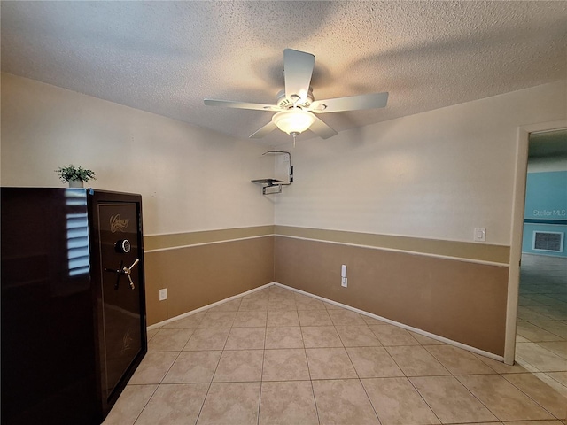 3357 Hunt Club Dr, Clearwater, FL 33761 - empty room with ceiling fan, light tile patterned floors, and a textured ceiling