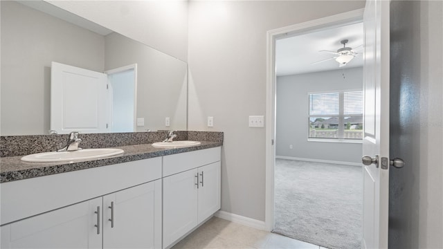 bathroom featuring double vanity, baseboards, and ceiling fan
