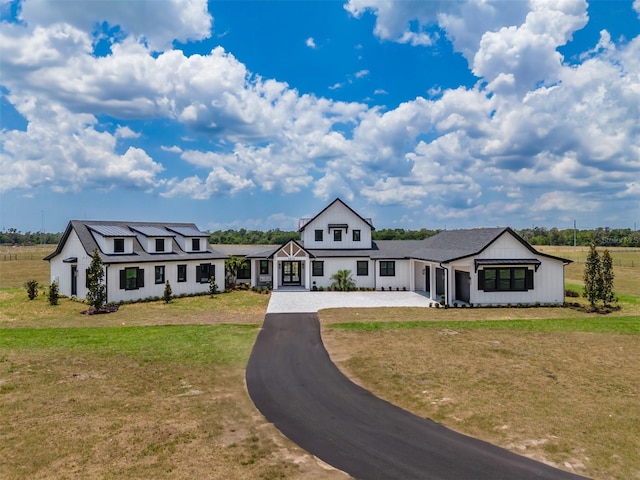 3515 Powerline Rd, Lithia, FL 33547 - modern inspired farmhouse featuring board and batten siding, a front lawn, and driveway
