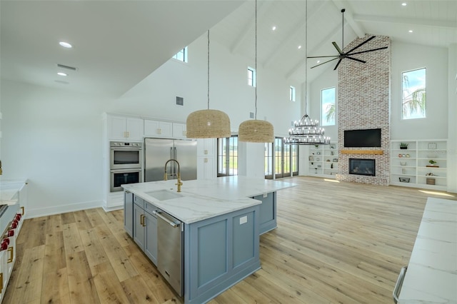 3515 Powerline Rd, Lithia, FL 33547 - kitchen with appliances with stainless steel finishes, high vaulted ceiling, a sink, light wood-style floors, and ceiling fan