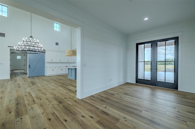 3515 Powerline Rd, Lithia, FL 33547 - unfurnished dining area with french doors, light wood-type flooring, a chandelier, and recessed lighting