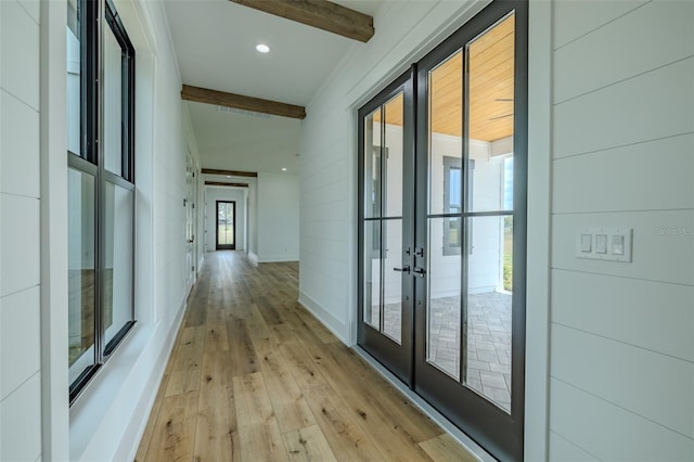 3515 Powerline Rd, Lithia, FL 33547 - corridor featuring french doors, beam ceiling, light wood finished floors, and baseboards