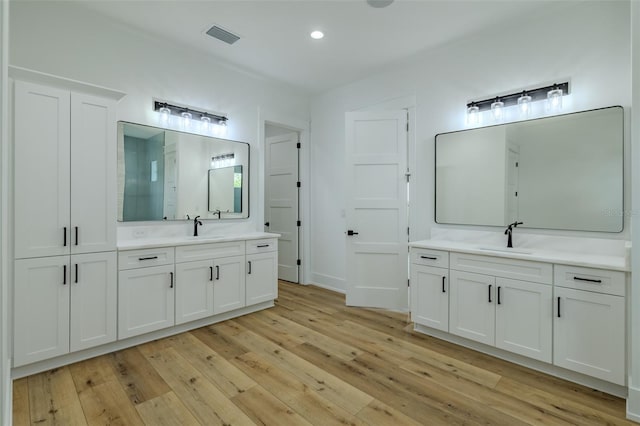 3515 Powerline Rd, Lithia, FL 33547 - bathroom with hardwood / wood-style flooring, two vanities, recessed lighting, and a shower