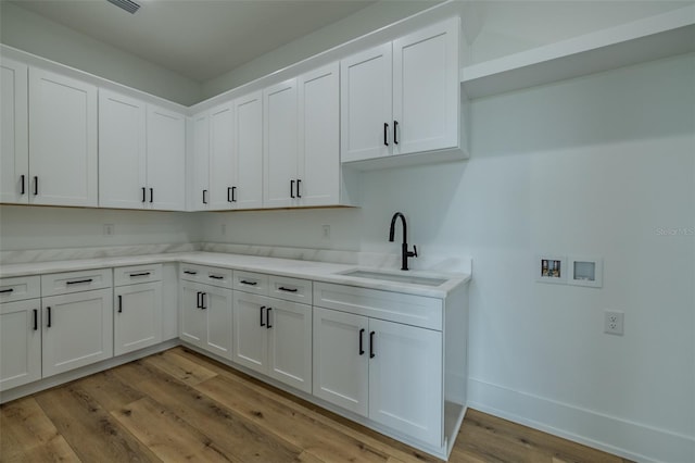 3515 Powerline Rd, Lithia, FL 33547 - washroom featuring washer hookup, cabinet space, light wood-style floors, and baseboards