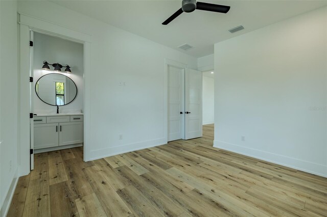 3515 Powerline Rd, Lithia, FL 33547 - unfurnished bedroom featuring light wood-style floors, baseboards, connected bathroom, and ceiling fan