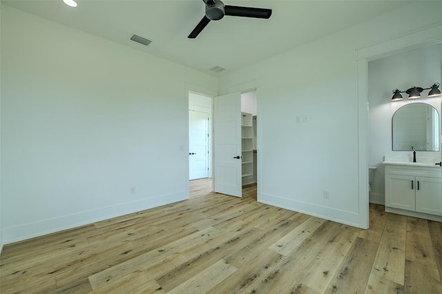 3515 Powerline Rd, Lithia, FL 33547 - unfurnished bedroom with a spacious closet, light wood-style flooring, baseboards, and ensuite bath