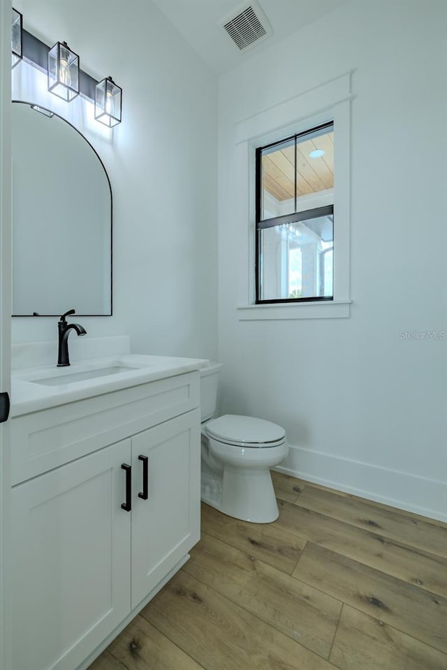 3515 Powerline Rd, Lithia, FL 33547 - bathroom featuring toilet, vanity, wood finished floors, and baseboards