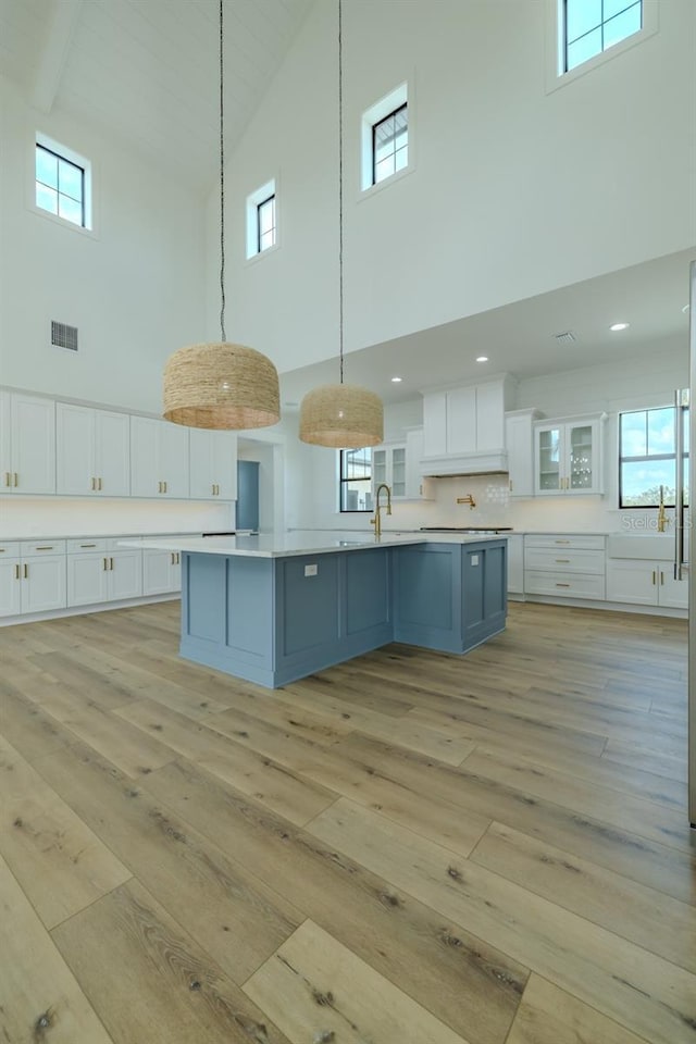 3515 Powerline Rd, Lithia, FL 33547 - kitchen featuring high vaulted ceiling, light wood-style floors, white cabinets, and light countertops