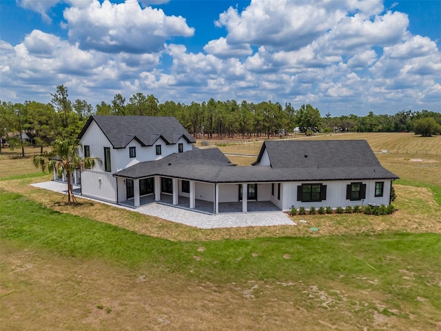 3515 Powerline Rd, Lithia, FL 33547 - rear view of house with a patio area, a lawn, and roof with shingles
