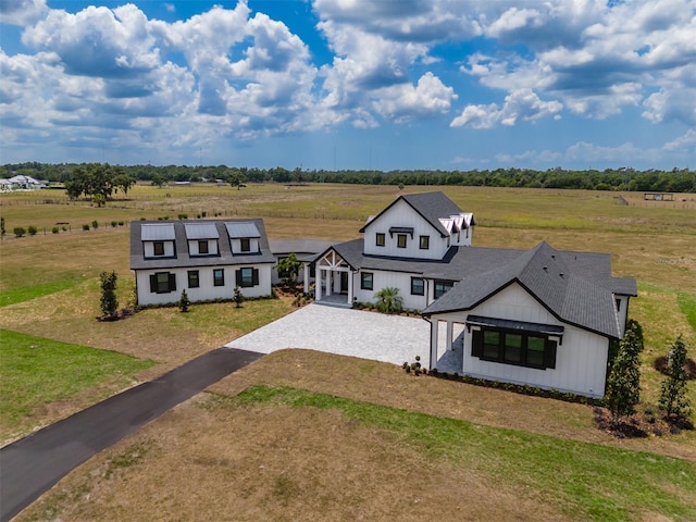 3515 Powerline Rd, Lithia, FL 33547 - view of front facade featuring driveway, board and batten siding, a front lawn, and a rural view