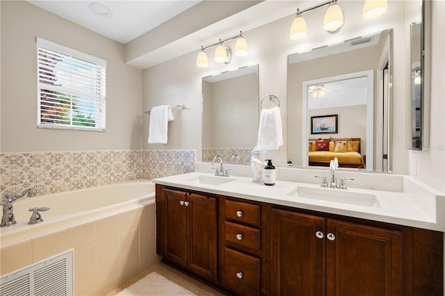 20039 Heritage Point Dr, Tampa, FL 33647 - full bath with ensuite bathroom, a garden tub, double vanity, a ceiling fan, and tile patterned floors