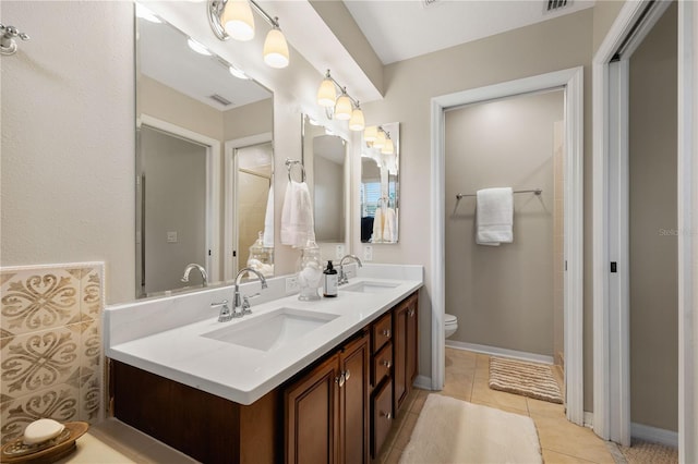 20039 Heritage Point Dr, Tampa, FL 33647 - bathroom featuring toilet, tile patterned flooring, and double vanity