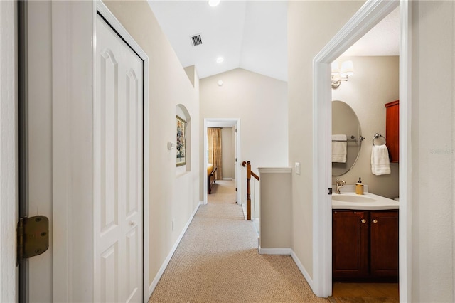 20039 Heritage Point Dr, Tampa, FL 33647 - hall featuring an upstairs landing, a sink, lofted ceiling, light carpet, and baseboards