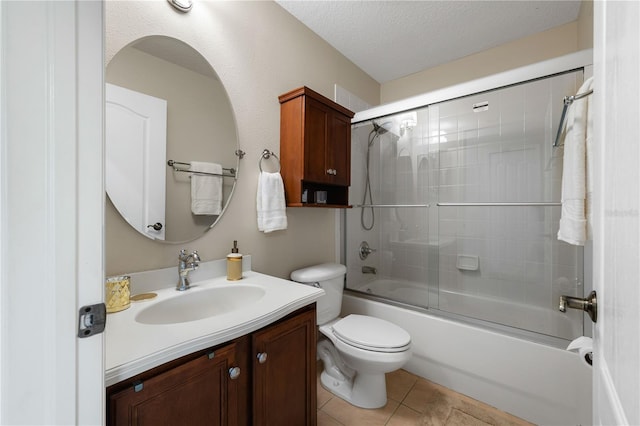 20039 Heritage Point Dr, Tampa, FL 33647 - full bath featuring toilet, shower / bath combination with glass door, vanity, a textured ceiling, and tile patterned floors