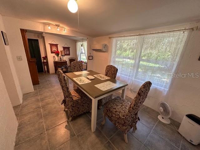 10170 W Yulee Dr, Homosassa, FL 34448 - tiled dining space featuring a wall mounted AC