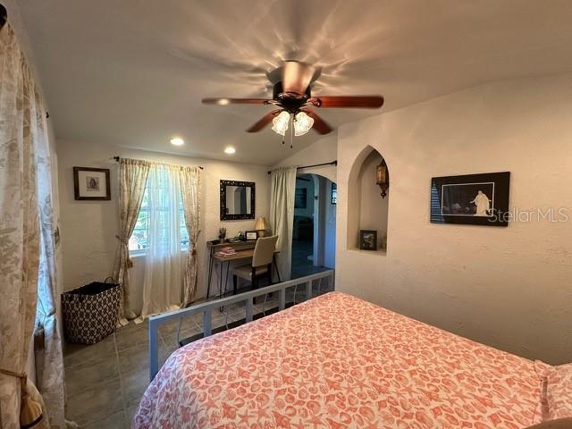 10170 W Yulee Dr, Homosassa, FL 34448 - tiled bedroom featuring arched walkways, an office area, recessed lighting, and a ceiling fan