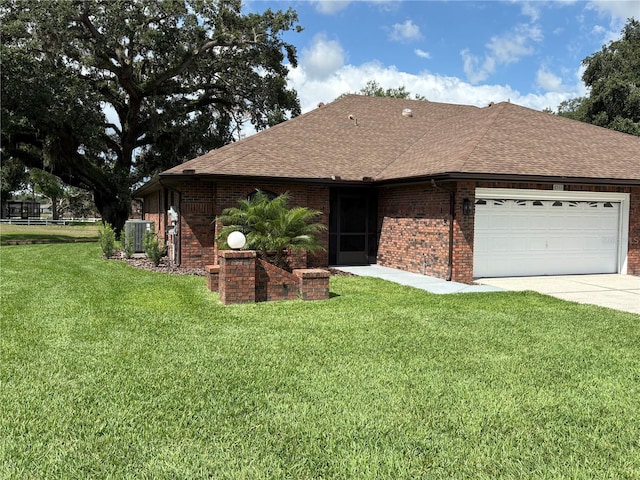 6533 Brentwood Dr, Zephyrhills, FL 33542 - ranch-style house with roof with shingles, brick siding, an attached garage, and a front yard