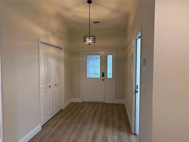 6533 Brentwood Dr, Zephyrhills, FL 33542 - entryway with wood finished floors, baseboards, and a towering ceiling