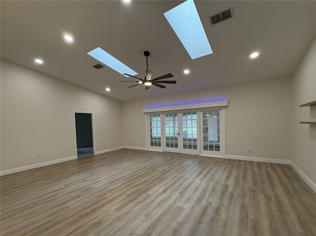 6533 Brentwood Dr, Zephyrhills, FL 33542 - unfurnished living room featuring a skylight, wood finished floors, baseboards, ceiling fan, and recessed lighting
