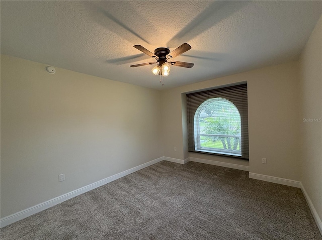 6533 Brentwood Dr, Zephyrhills, FL 33542 - unfurnished room featuring a ceiling fan, a textured ceiling, dark carpet, and baseboards