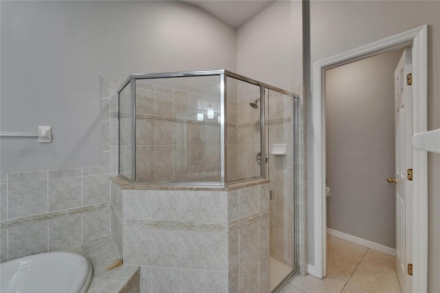 6801 Bishops Pointe Way, Riverview, FL 33578 - bathroom featuring a shower stall, a bath, and tile patterned floors