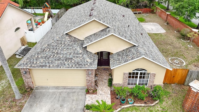 6801 Bishops Pointe Way, Riverview, FL 33578 - view of front facade with a shingled roof, a garage, and a fenced backyard