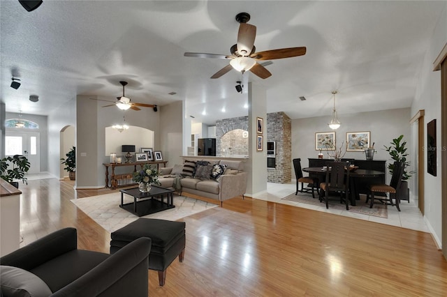 6801 Bishops Pointe Way, Riverview, FL 33578 - living room featuring arched walkways, light wood-type flooring, and ceiling fan