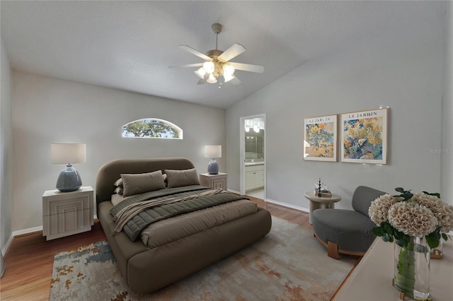 6801 Bishops Pointe Way, Riverview, FL 33578 - bedroom featuring wood finished floors, vaulted ceiling, ensuite bath, and ceiling fan