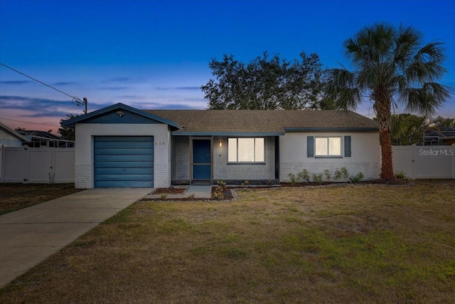 ranch-style home featuring brick siding, concrete driveway, a garage, and a gate