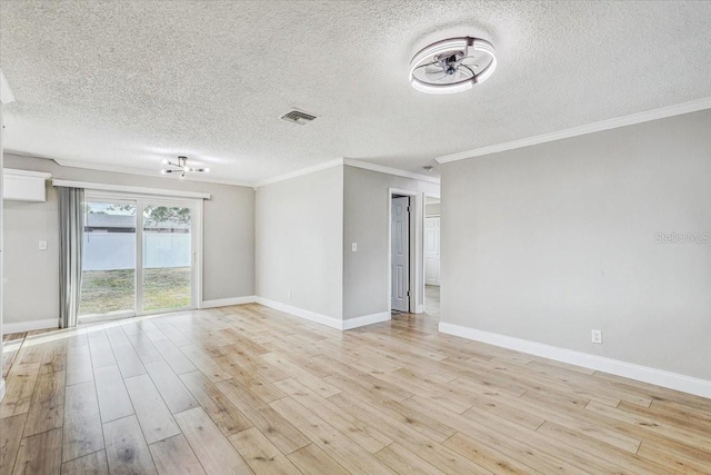 empty room with light wood-type flooring, ornamental molding, a textured ceiling, and baseboards