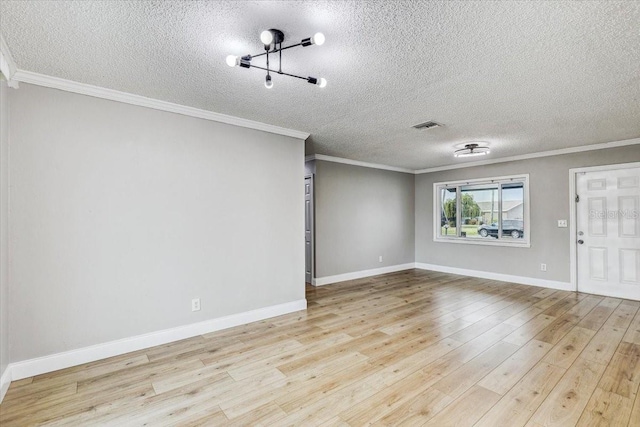 unfurnished room with a textured ceiling, light wood-type flooring, crown molding, and baseboards