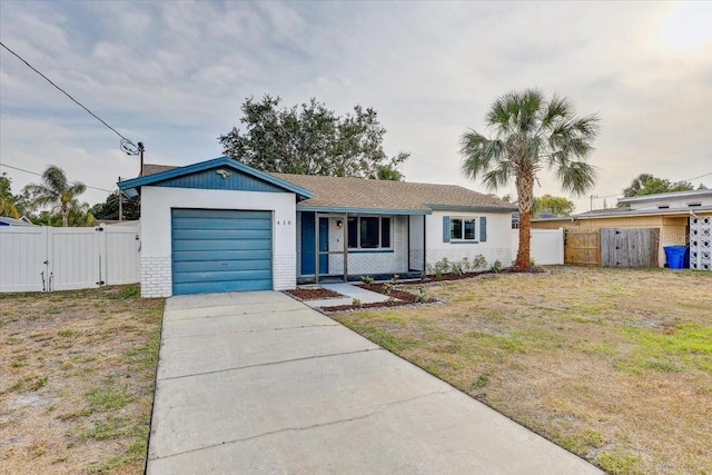 ranch-style home featuring a gate, concrete driveway, an attached garage, brick siding, and a porch