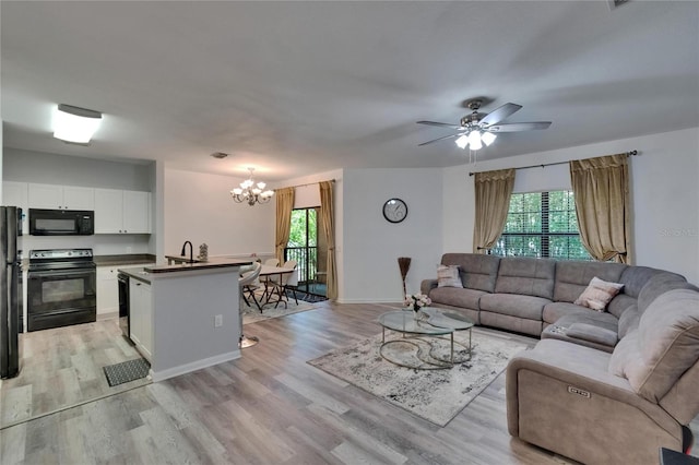 2220 Chianti Pl Unit 8-0828, Palm Harbor, FL 34683 - living area with a chandelier, healthy amount of natural light, and light wood-style flooring