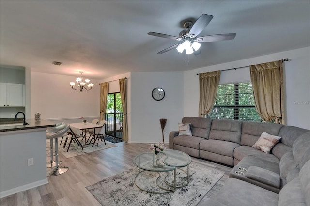 2220 Chianti Pl Unit 8-0828, Palm Harbor, FL 34683 - living area featuring plenty of natural light, a chandelier, light wood-style flooring, and ceiling fan
