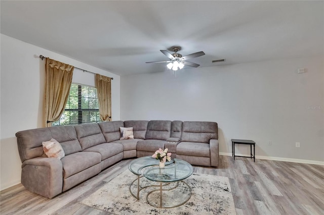 2220 Chianti Pl Unit 8-0828, Palm Harbor, FL 34683 - living area featuring light wood finished floors, ceiling fan, and baseboards