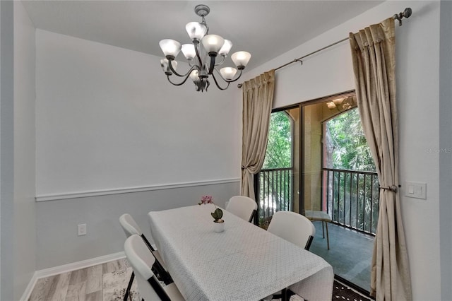 2220 Chianti Pl Unit 8-0828, Palm Harbor, FL 34683 - dining room featuring a chandelier, baseboards, and wood finished floors